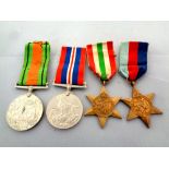 Four World War II medals on ribbons to include The War Medal, The Defence Medal,