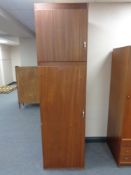 A mid 20th century teak effect wardrobe fitted cupboard above,