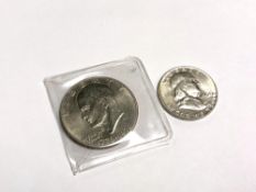 An American 1776-1976 dollar together with a 1954 half dollar