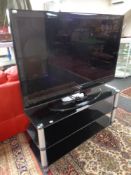 A Samsung 46'' LCD TV with remote on stand