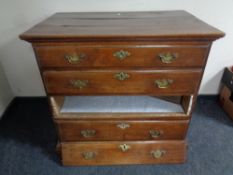 A George III elm four drawer chest with brass drop handles (as found)
