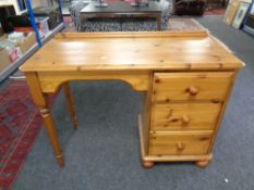 A pine kneehole dressing table fitted three drawers together with a contemporary bedside table