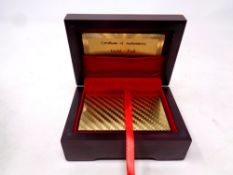 A pack of 24ct gold foil playing cards in a fitted box