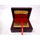 A pack of 24ct gold foil playing cards in a fitted box