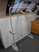 A 20th century metal clothes rail fitted with shelf and umbrella stand