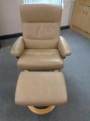 A Stressless swivel adjustable armchair and stool upholstered in a beige leather