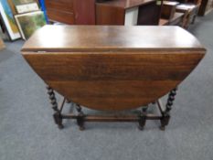 An Edwardian oak barley twist gate leg table