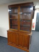 A 19th century double door glazed bookcase fitted cupboards beneath