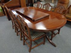 A Regency style twin pedestal dining table with two leaves together with a set of six shield back