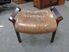 A stained beechwood leather upholstered footstool