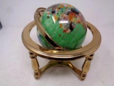 A gemstone globe on stand