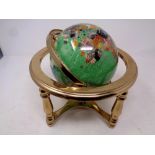 A gemstone globe on stand