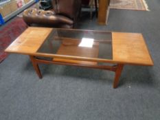A teak G Plan coffee table with undershelf fitted with a smoked glass panel,