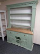 A painted pine welsh dresser fitted cupboards and drawers beneath