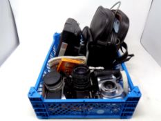 A basket containing cameras and accessories to include a Kodak EK160-EF,