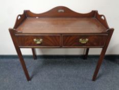 A Regency style two drawer side table with gallery