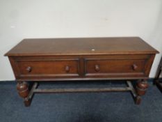 An oak two drawer dresser base on bulbous legs