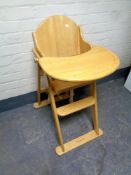 A folding pine Mother Care high chair