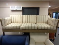 A 20th century Erik Jorgensen three seater settee upholstered in a beige striped fabric