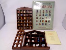 A large wooden thimble stand together with three further thimble stands containing a large quantity