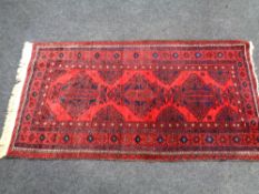 An Afghan rug of geometric design,