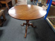 A Victorian oak circular tilt top pedestal table