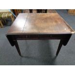 A 19th century mahogany flap sided table fitted two drawers on reeded legs