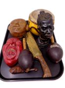 A tray of tourist pieces, pottery masks, hand drum,