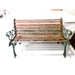 A cast iron wooden slatted garden bench