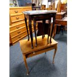 A twentieth century walnut two tier occasional table together with a nest of two tables