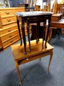 A twentieth century walnut two tier occasional table together with a nest of two tables