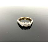 An 18ct yellow gold three stone diamond ring, set with diamond shoulders, size K/L, 3.1g.