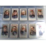 An album of wills and players cigarette cards including Products of the world, cap badges,