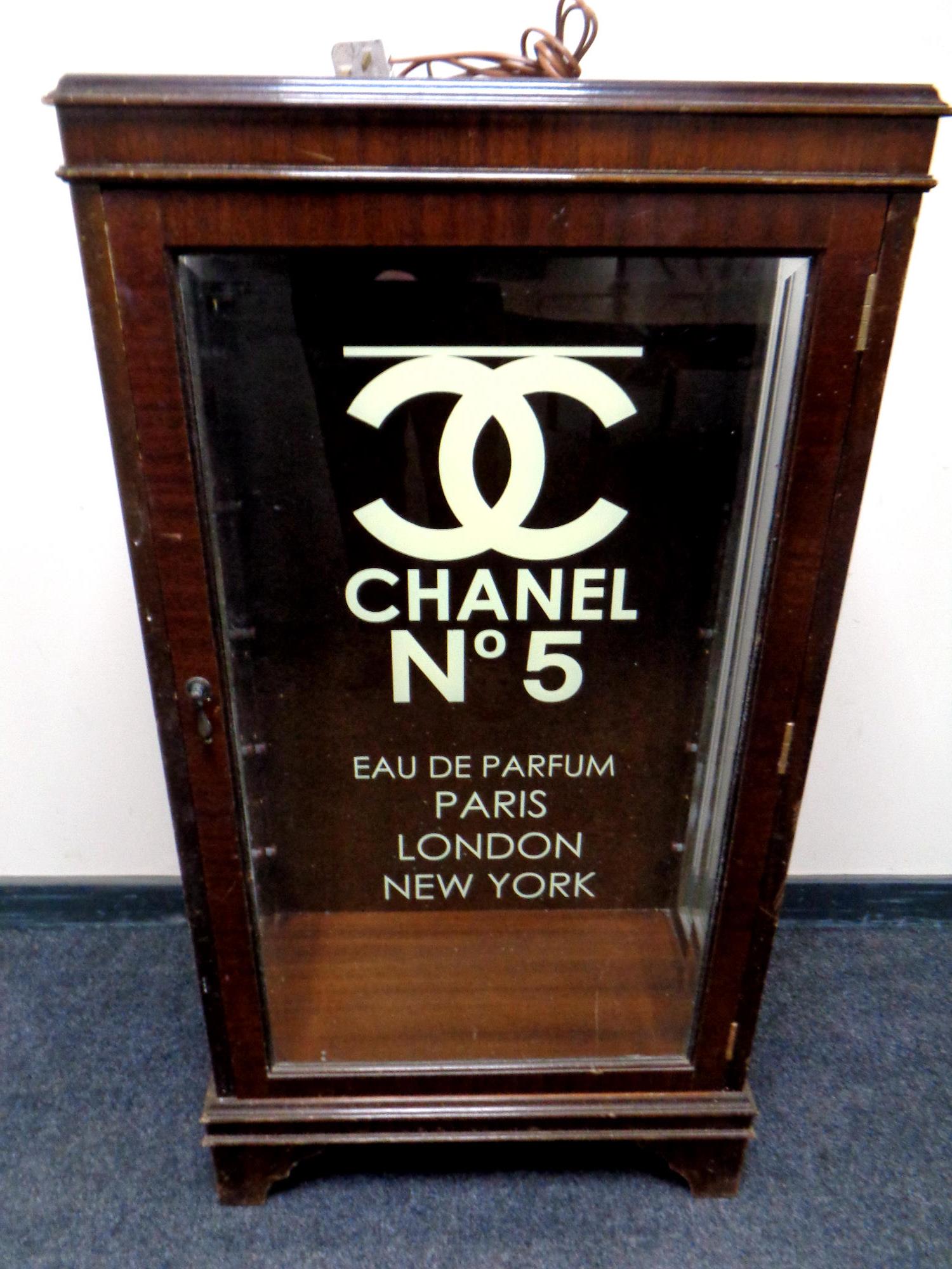 An inlaid mahogany display cabinet bearing later Chanel advertising