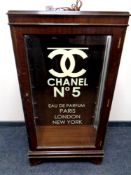 An inlaid mahogany display cabinet bearing later Chanel advertising