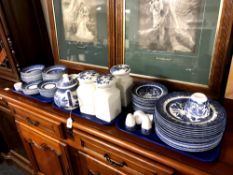 A quantity of blue and white Willow pattern china, dinner plates, bowls, egg cups,