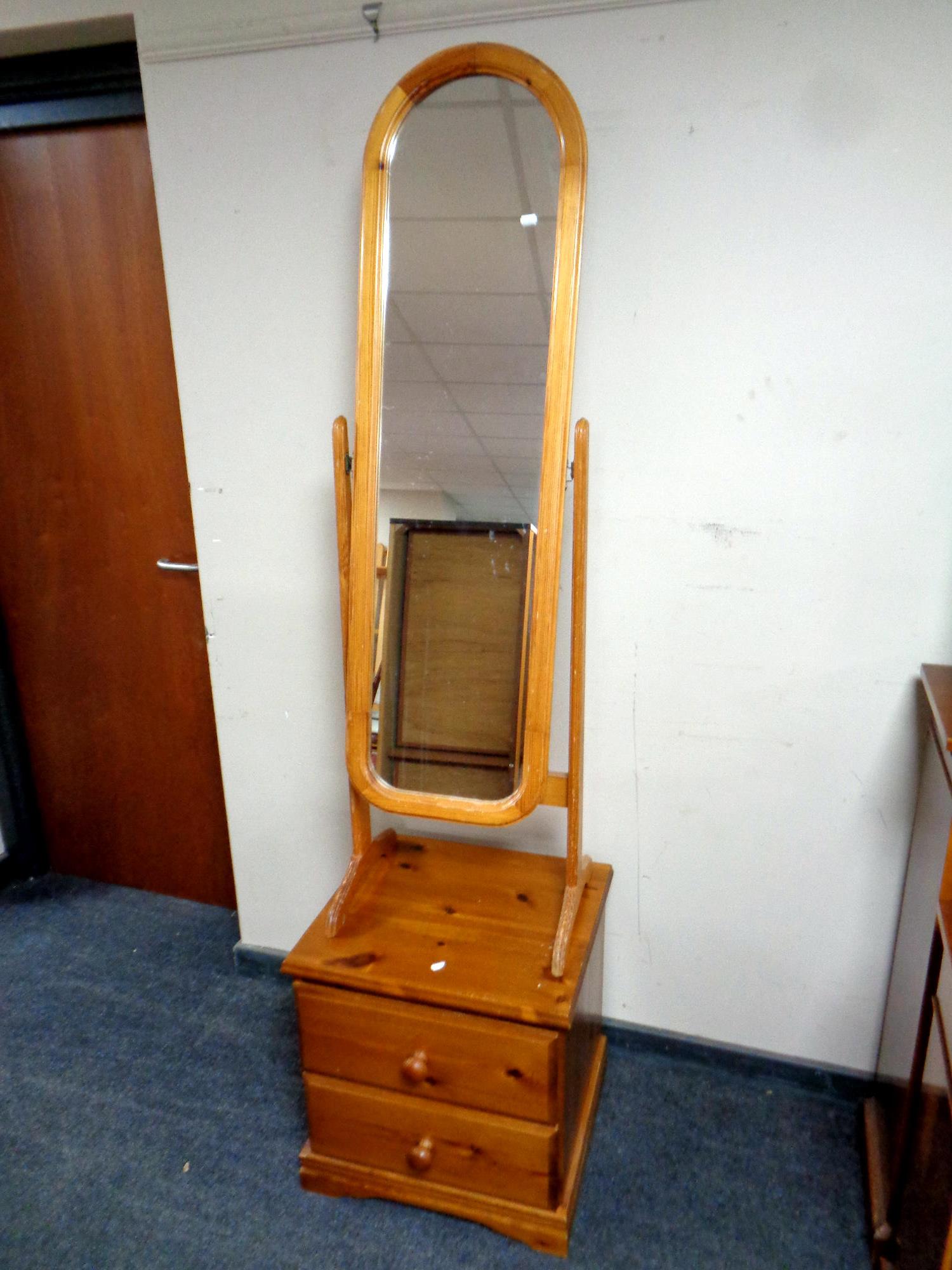 A pine two drawer bedside chest together with a pine cheval mirror
