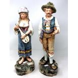 A pair of Victorian Majolica figures of a gentleman and lady,