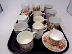 A tray of antique and later commemorative mugs and beakers,