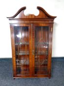 A mahogany wall mounted double door display cabinet