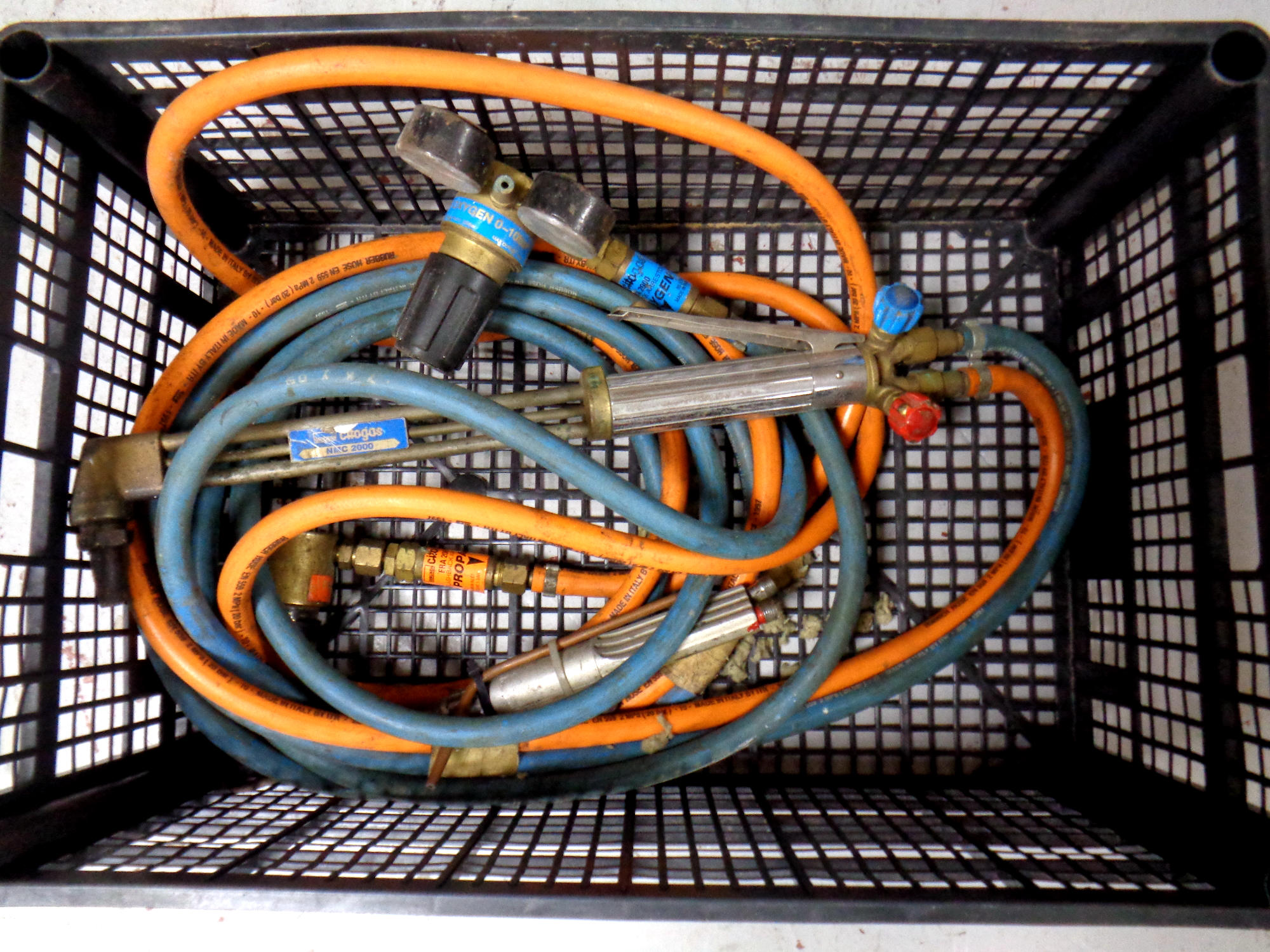 A crate of welding torches and hoses