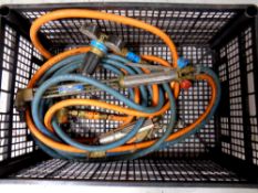 A crate of welding torches and hoses