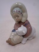 A Lladro figure Eskimo boy with polar bear cub