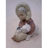 A Lladro figure Eskimo boy with polar bear cub