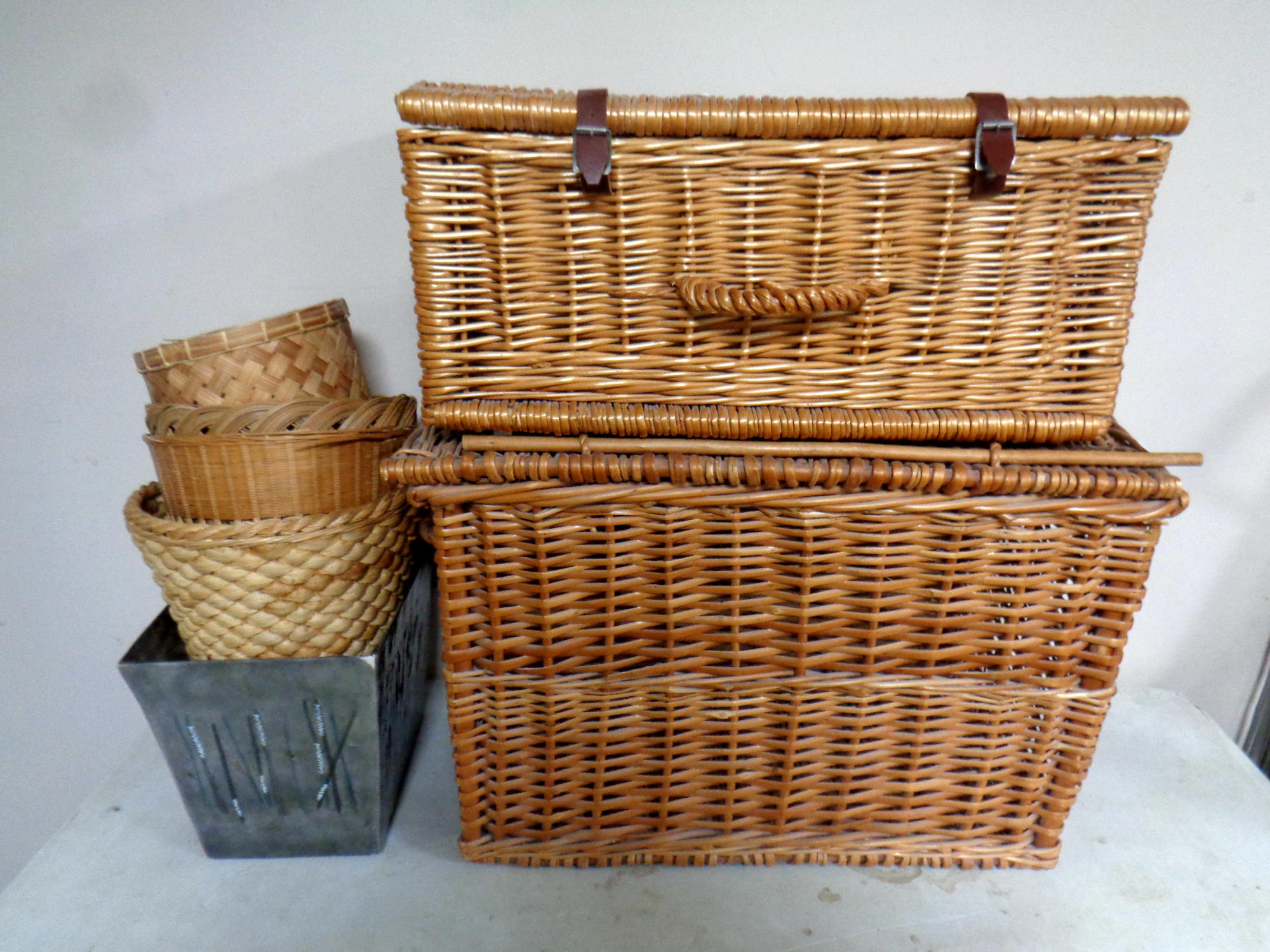 Two wicker picnic hampers together with four metal and wicker waste paper bins