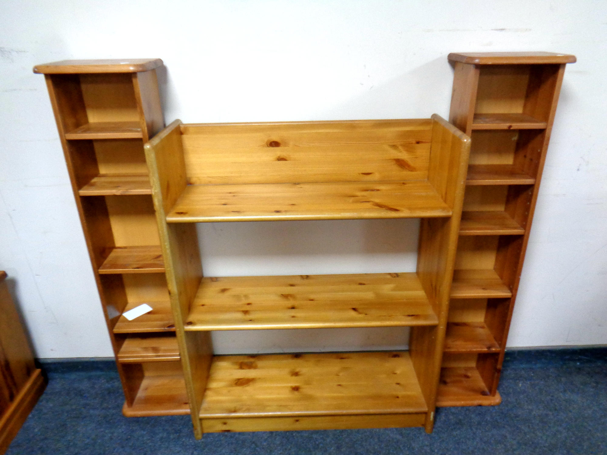 A set of pine open shelves together with two media stands