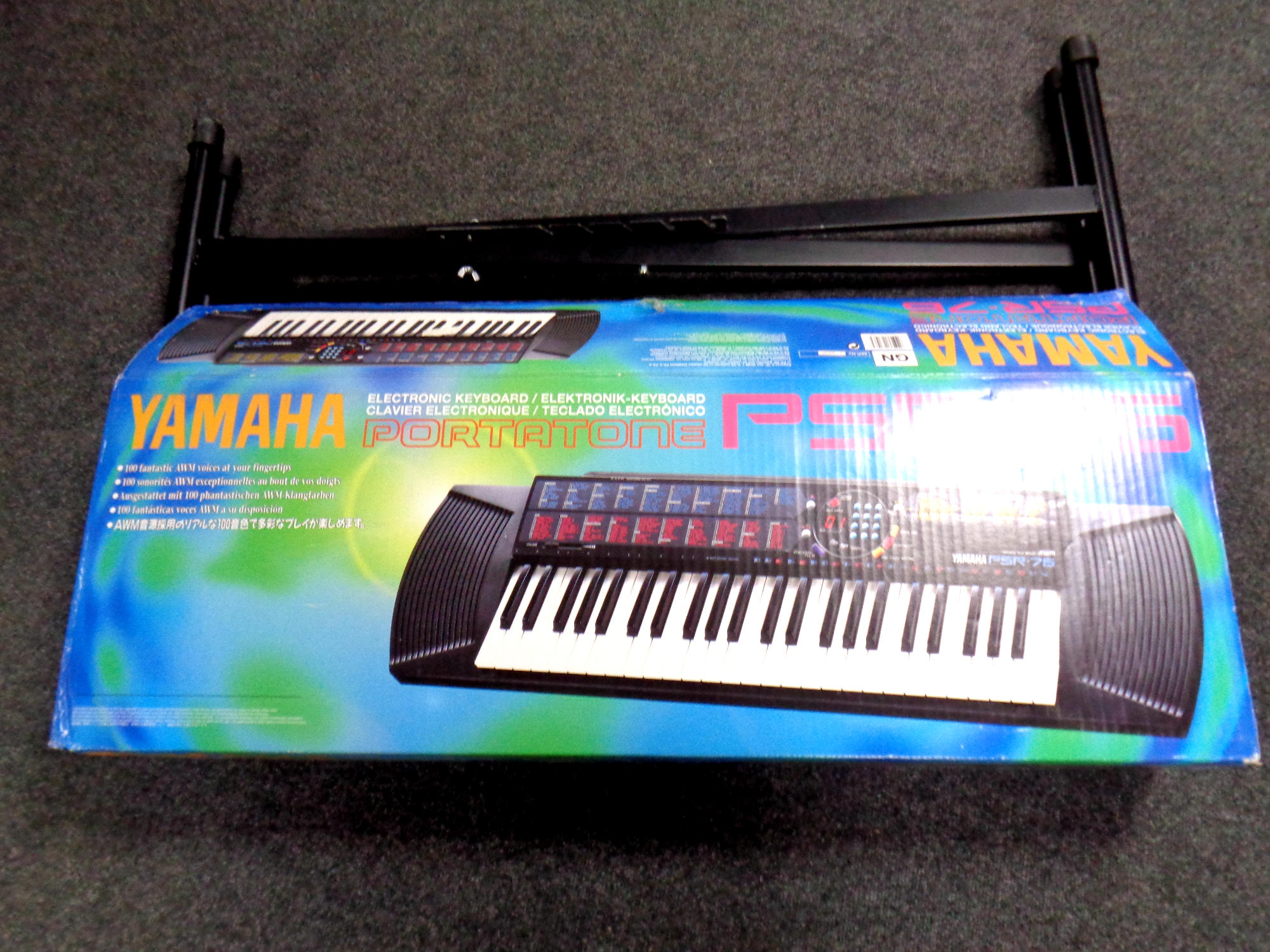 A Yamaha portatone PSR76 electric keyboard in box together with keyboard stand