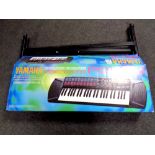 A Yamaha portatone PSR76 electric keyboard in box together with keyboard stand