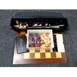 A wooden chess board together with chess pieces, folding travel board,