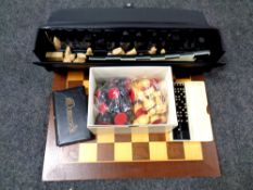 A wooden chess board together with chess pieces, folding travel board,